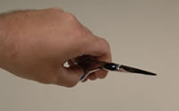 Incorrect position - closing shear using both fingers and thumb
